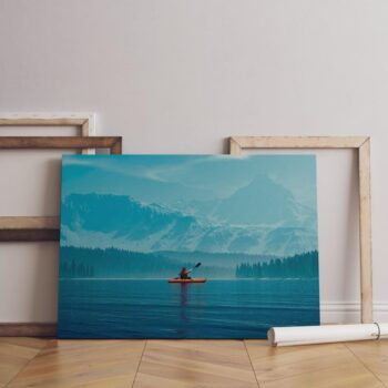 Woman kayaking into a lake  with mountains Canvas Wall Art 90x60